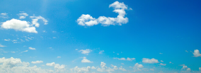 Blue sky background with clouds. Wide photo.