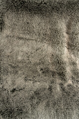 Graues weiches und flauschiges Schaffell als Hintergrund