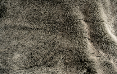 Graues weiches und flauschiges Schaffell als Hintergrund