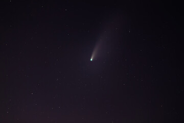 Comet NEOWISE or C/2020 F3 (NEOWISE) with cloud in the night sky.