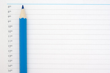 Blue sharp pencil on the page of the schedule