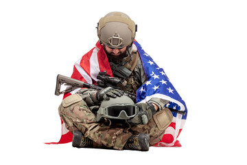 american soldier in military equipment with usa flag sad over loss of comrade, ranger holds helmet of dead soldier and regrets