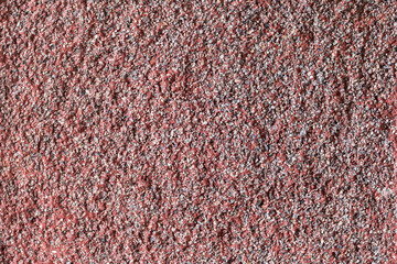 red plaster covered with small stones