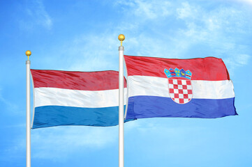 Netherlands and Croatia two flags on flagpoles and blue sky