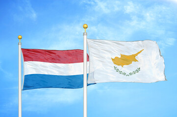 Netherlands and Cyprus two flags on flagpoles and blue sky