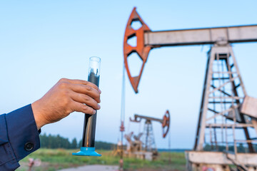 oil industry. a test tube with crude oil in the hand of an engineer © Сергей Храмов