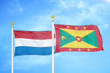 Netherlands and Grenada two flags on flagpoles and blue sky