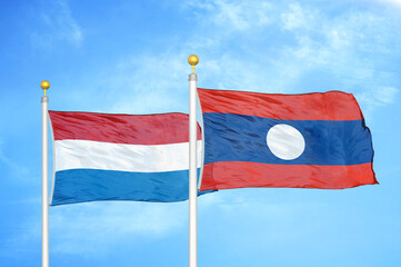 Netherlands and Laos two flags on flagpoles and blue sky