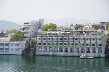 Multi-family residential buildings next to the lake. They provide the residents of the flats with direct contact with nature and water. Udaipur India - July 2020