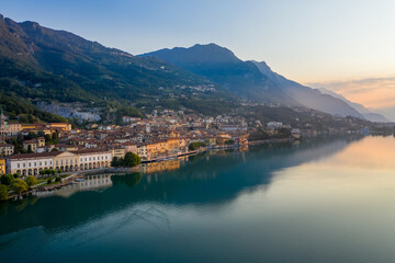 Fototapeta na wymiar Aerial view of Lake Iseo at sunrise, on the left the city of lovere which runs along the lake,Bergamo Italy.