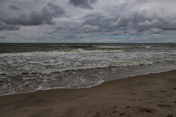 wide beach on the Baltic Sea in Poland on a summer cloudy gray cold day