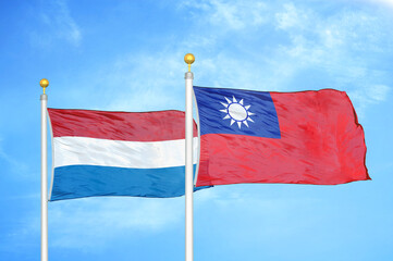 Netherlands and Taiwan two flags on flagpoles and blue sky