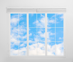 Fototapeta na wymiar Beautiful view on blue sky with clouds through window