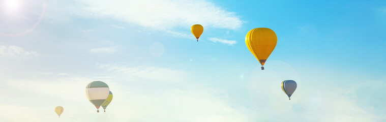 Hot air balloons in blue sky. Banner design