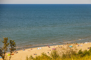 view from the escarpment to the beach on the Baltic Sea on a summer day with people