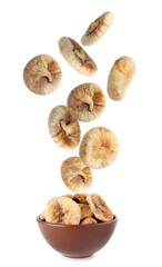 Dried fig fruits falling into bowl on white background