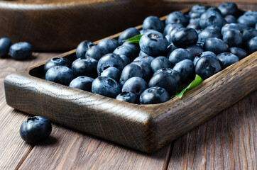 Fresh juicy blueberries on a wooden background