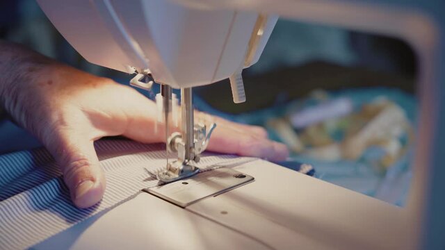 Close-up, Old Woman's Hands Sew Dress on Sewing Machine