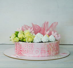 pink stencil cake with roses and merengue for anniversary