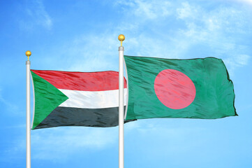 Sudan and Bangladesh two flags on flagpoles and blue sky