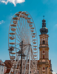 Beautiful ferris wheel with a church in the background at Deggendorf, Bavaria, Germany during the corona pandemic