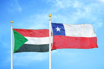 Sudan and Chile two flags on flagpoles and blue sky