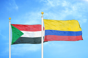 Sudan and Colombia two flags on flagpoles and blue sky