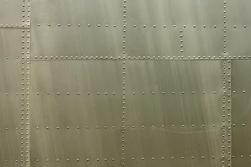 Papier peint photo Ancien avion Details of the fuselage of an old aircraft. Old camouflage surface with exfoliated paint and rivets on a military aircraft.  © Roman