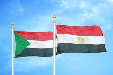 Sudan and Egypt two flags on flagpoles and blue sky