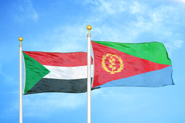Sudan and Eritrea two flags on flagpoles and blue sky