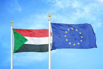 Sudan and European Union two flags on flagpoles and blue sky