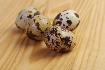 Quail eggs on a wooden table.