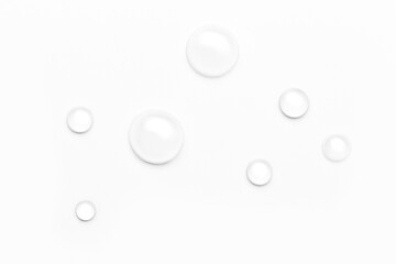 drops of water on a white background, top view