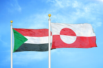 Sudan and Greenland two flags on flagpoles and blue sky