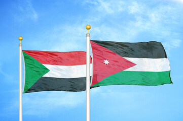 Sudan and Jordan two flags on flagpoles and blue sky