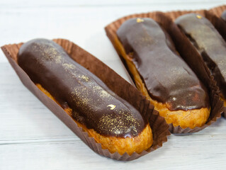 Gorgeous extra chocolate eclairs with gilded glaze