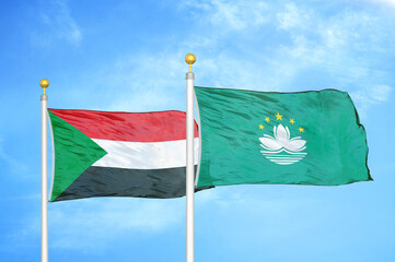 Sudan and Macau two flags on flagpoles and blue sky