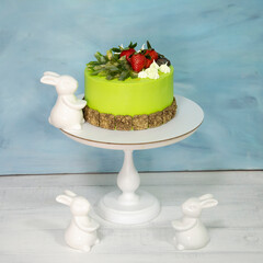 A green creamchease cake with berries and marmalade
