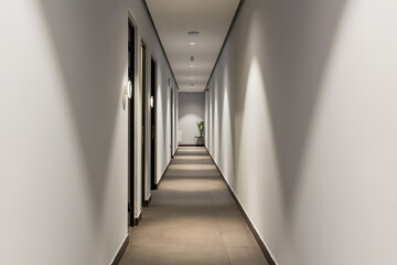 Interior of a long hotel corridor