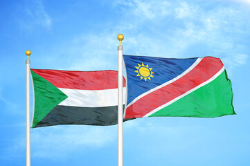 Naklejka na ściany i meble Sudan and Namibia two flags on flagpoles and blue sky