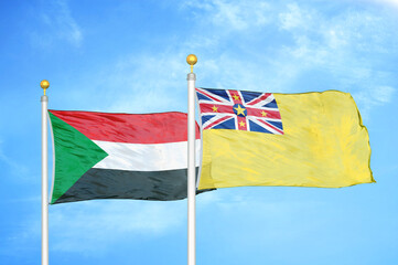 Sudan and Niue two flags on flagpoles and blue sky