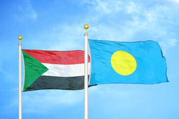 Fototapeta na wymiar Sudan and Palau two flags on flagpoles and blue sky