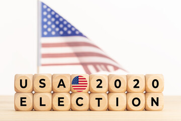 USA 2020 presidential election concept. Wooden block with text and american flag. Copy space