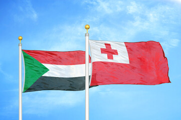 Sudan and Tonga two flags on flagpoles and blue sky