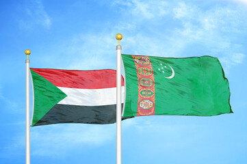 Naklejka na ściany i meble Sudan and Turkmenistan two flags on flagpoles and blue sky