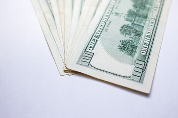 One hundred dollar bills on a white background