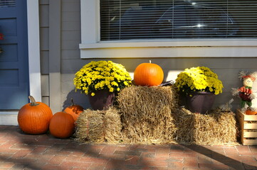 Orange pumpkins and hay stacks as symbols of Autumn and the Fall season © Jeri