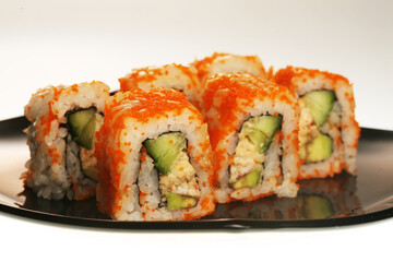 japanese rolls on black plate.