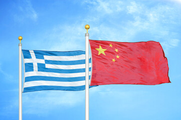 Greece and China two flags on flagpoles and blue sky