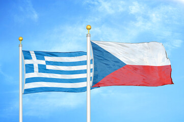 Greece and Czech Republic two flags on flagpoles and blue sky